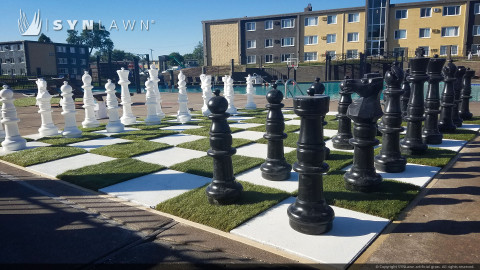 Giant chessboard on artificial grass
