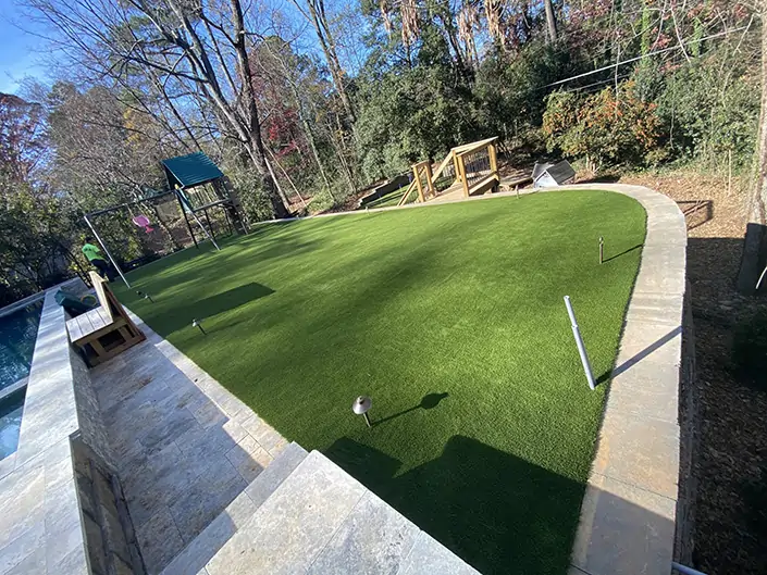 Artificial grass backyard pool and play area